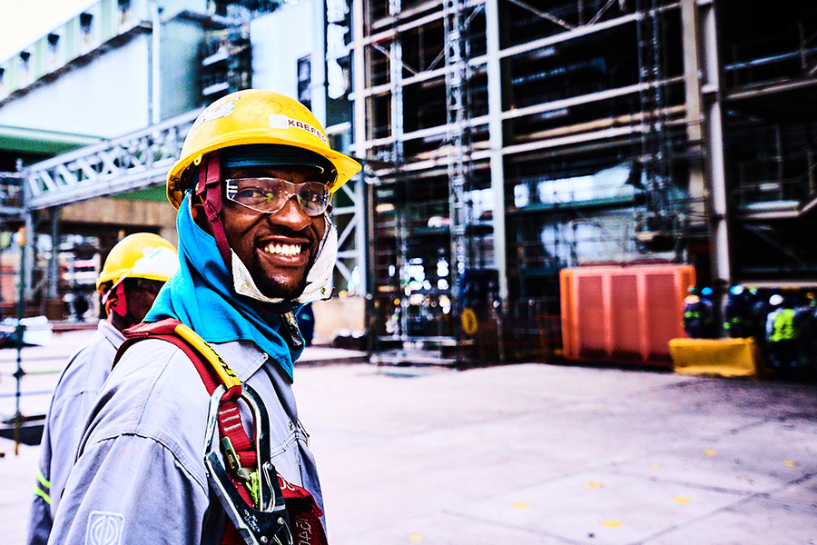Scaffolder on site in full PPE, smiling at the camera
